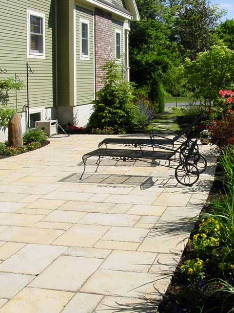 paver patio with two wrought iron chaises