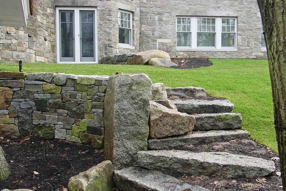 combined elements create visual interest in these stone steps and retaining wall