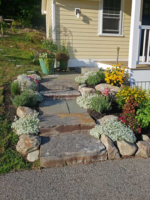 stone steps create an informal approach to farmer's porch