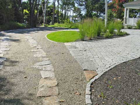 natural stone driveway with a variety of treatments including gravel, pads, pavers