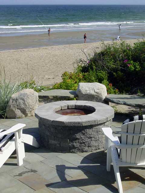 a custom fire pit overlooking the beach and ocean