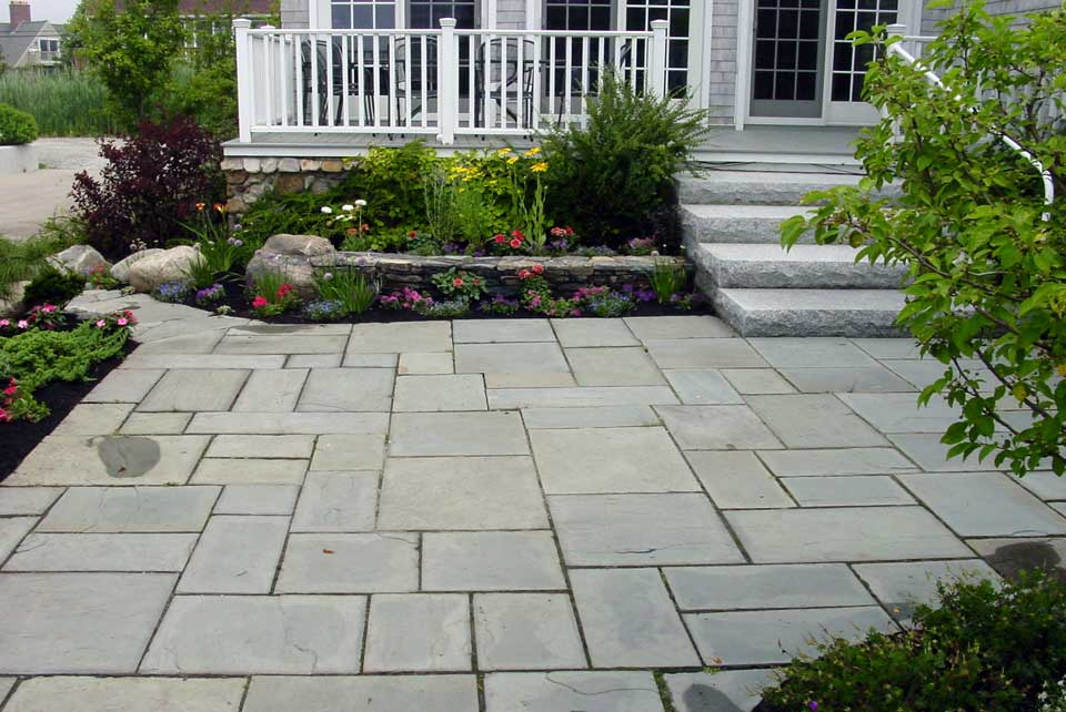 stone patio at entryway to home, stone steps