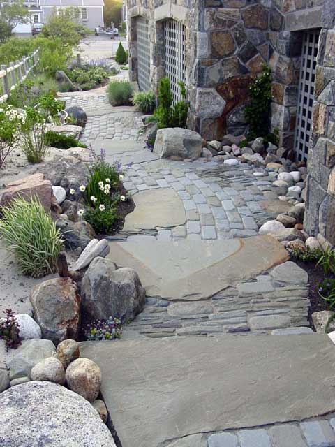 pathway created with multiple shapes and sizes of stone including beach pebbles
