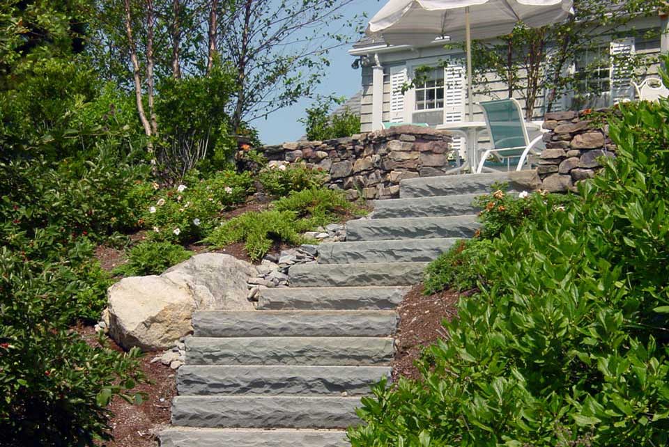 large stone slab stairs connect steep grade