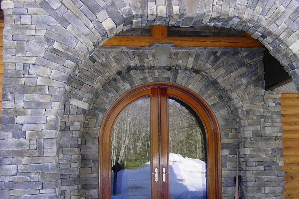 front entry is defined and enhanced by applied stone veneer