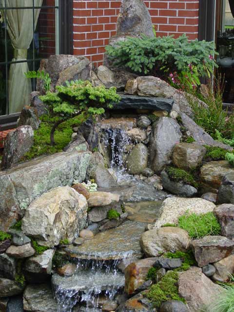 water feature with plantings and waterfall